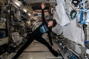 Female astronaut practicing yoga in the International Space Station