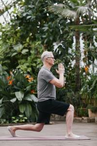 Oldman practicing Yoga outdoors
